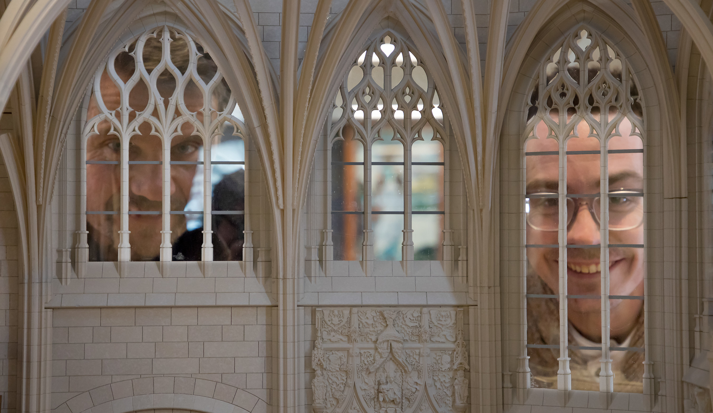 Image of people looking in windows of Folleville church model